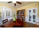 Bright dining room features hardwood floors, large bookcase, and double doors for easy access at 2553 Twilight Vw, Snellville, GA 30078