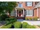Charming front entrance with a red door framed by white columns and manicured landscaping at 2553 Twilight Vw, Snellville, GA 30078
