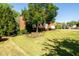 Well-maintained front yard with lush lawn, mature trees, and landscaping surrounding an elegant brick home at 2553 Twilight Vw, Snellville, GA 30078