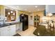 Well-lit kitchen with black refrigerator, tile floors and granite counters at 2553 Twilight Vw, Snellville, GA 30078