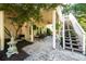 Covered outdoor patio with outdoor seating and stairs leading to an upper deck at 2553 Twilight Vw, Snellville, GA 30078