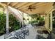 Covered outdoor patio with furniture and staircase surrounded by lush foliage at 2553 Twilight Vw, Snellville, GA 30078