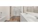 Bathroom features a double sink vanity, soaking tub, and walk-in shower at 310 Silver Moon Drive # 111, Loganville, GA 30052