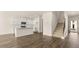 Bright and open kitchen with hardwood floors, white cabinets and view of staircase at 310 Silver Moon Drive # 111, Loganville, GA 30052