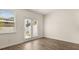 Bright living room with light-colored wood-style flooring, large window, and access to the patio at 310 Silver Moon Drive # 111, Loganville, GA 30052