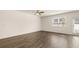 Open living area with hardwood floors, ceiling fan, and bright natural light from windows and door at 310 Silver Moon Drive # 111, Loganville, GA 30052