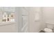 Neat powder room with white toilet and window view, offering practical elegance at 310 Silver Moon Drive # 111, Loganville, GA 30052