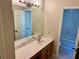 A bathroom featuring a white sink with a marble-patterned countertop and a large mirror at 999 Grassdale Rd, Cartersville, GA 30121
