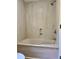 A bathroom featuring a shower and tub combination with a marble-patterned wall at 999 Grassdale Rd, Cartersville, GA 30121