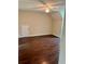 A bedroom featuring hardwood floors, a ceiling fan, and neutral-colored walls at 999 Grassdale Rd, Cartersville, GA 30121