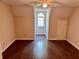 A bedroom featuring hardwood floors, a window, and neutral-colored walls at 999 Grassdale Rd, Cartersville, GA 30121