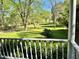 View from the porch to a large, grassy front yard with mature trees and established landscaping at 999 Grassdale Rd, Cartersville, GA 30121