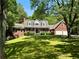 Charming brick home with a red door, dormer windows, two-car garage and a well-manicured lawn at 999 Grassdale Rd, Cartersville, GA 30121
