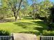 View from a porch of a spacious front yard with mature trees and landscaping with driveway to the street at 999 Grassdale Rd, Cartersville, GA 30121