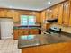 Kitchen with oak cabinetry, tiled backsplash, and granite countertops at 999 Grassdale Rd, Cartersville, GA 30121