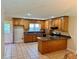 Spacious kitchen with tile flooring, oak cabinets, and breakfast bar at 999 Grassdale Rd, Cartersville, GA 30121