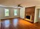 Spacious living room features a brick fireplace and hardwood floors at 999 Grassdale Rd, Cartersville, GA 30121