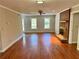 Large living room with hardwood floors, brick fireplace, neutral paint and many windows overlooking the yard at 999 Grassdale Rd, Cartersville, GA 30121