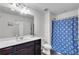 Bright bathroom featuring white vanity, patterned shower curtain, and modern fixtures at 1929 Millstream Holw, Conyers, GA 30012