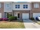 Charming townhome with brick facade, attached garage, and well-maintained landscaping at 1929 Millstream Holw, Conyers, GA 30012