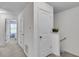 Hallway leading to bedrooms with carpet floors and modern white doors at 1929 Millstream Holw, Conyers, GA 30012