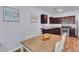 Well-lit kitchen features granite countertops and modern appliances, connected to the dining area at 1929 Millstream Holw, Conyers, GA 30012