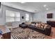 Stylish living room featuring a plush sectional, patterned rug, and natural light at 1929 Millstream Holw, Conyers, GA 30012