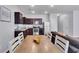 Open concept living space combining kitchen, dining, and living areas for seamless entertaining at 1929 Millstream Holw, Conyers, GA 30012