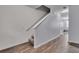 Clean staircase featuring wood floors and white banisters that complements the home's interior at 1929 Millstream Holw, Conyers, GA 30012