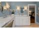 Bathroom with marble countertops, double sinks, and decorative light fixtures at 22 The Prado Ne, Atlanta, GA 30309