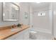 Bright bathroom with a shower-tub combo, a decorative window, and an elegant vanity at 22 The Prado Ne, Atlanta, GA 30309