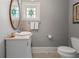 Powder room features stylish vanity, sink, and decorative mirror at 22 The Prado Ne, Atlanta, GA 30309