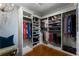 Spacious walk-in closet featuring custom shelving, ample hanging space, and hardwood floors at 22 The Prado Ne, Atlanta, GA 30309