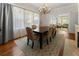 Bright dining room with hardwood floors, fireplace, chandelier, large windows, and seating for six at 22 The Prado Ne, Atlanta, GA 30309