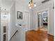 Upstairs hallway with hardwood floors, stylish lighting, and doorways to bedrooms at 22 The Prado Ne, Atlanta, GA 30309