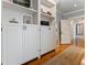 Hallway featuring built-in shelving and cabinets, and warm hardwood floors at 22 The Prado Ne, Atlanta, GA 30309