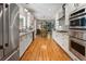 Long galley kitchen with modern stainless steel appliances and hardwood flooring at 22 The Prado Ne, Atlanta, GA 30309