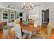 Open-concept kitchen and dining area with hardwood floors, plenty of natural light and fireplace in nearby living room at 22 The Prado Ne, Atlanta, GA 30309