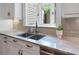 Kitchen features stainless steel sink, marble countertops, and updated cabinets at 22 The Prado Ne, Atlanta, GA 30309