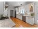 Bright kitchen features hardwood floors, stainless steel appliances, and white cabinetry at 22 The Prado Ne, Atlanta, GA 30309