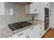 Close up of a kitchen features stainless steel stovetop and marble countertops at 22 The Prado Ne, Atlanta, GA 30309