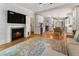 Open-concept living space with fireplace, hardwood floors, and views into the kitchen and dining area at 22 The Prado Ne, Atlanta, GA 30309