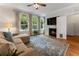Comfortable living room featuring hardwood floors, a fireplace, large windows and a plush sectional sofa at 22 The Prado Ne, Atlanta, GA 30309