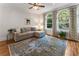 Cozy living room features large windows, hardwood floors, sectional sofa and stylish decor at 22 The Prado Ne, Atlanta, GA 30309
