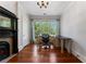 Inviting office space featuring hardwood floors, a vintage fireplace, and large windows at 22 The Prado Ne, Atlanta, GA 30309