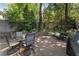 Landscaped outdoor patio with mature trees and a seating area at 22 The Prado Ne, Atlanta, GA 30309