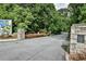 Street view of Atlanta Botanical Garden entrance with stone pillars and lush landscaping at 22 The Prado Ne, Atlanta, GA 30309