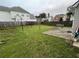 Large backyard with lush green grass, a wooden fence, and a patio area, perfect for outdoor activities at 2347 Fawn Hollow Ct, Duluth, GA 30096