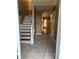 Foyer with new tile flooring, stairs and views into other living areas at 2347 Fawn Hollow Ct, Duluth, GA 30096
