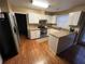 Bright kitchen featuring granite countertops, white cabinets, stainless steel appliances and hardwood floors at 2347 Fawn Hollow Ct, Duluth, GA 30096